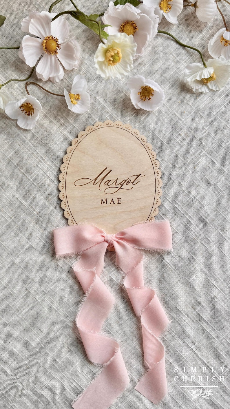 Engraved Margot Mae lace-trimmed name sign with pink ribbon