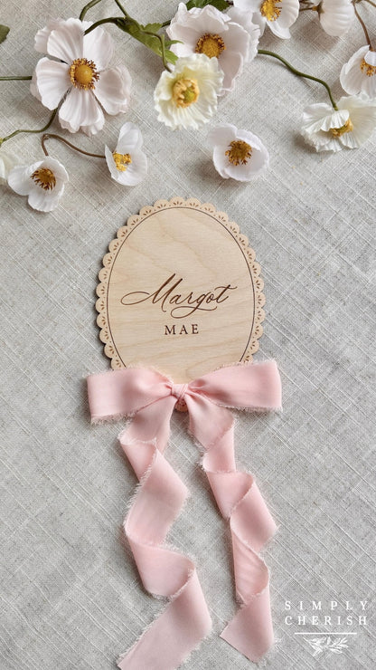 Engraved Margot Mae lace-trimmed name sign with pink ribbon