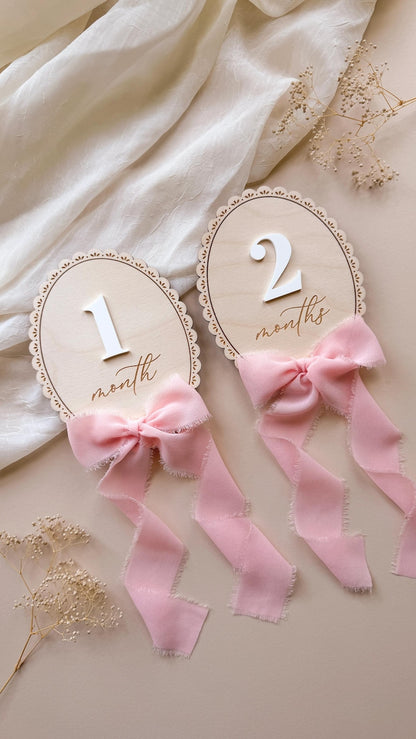 Month and months lace-trimmed signs with white acrylic numbers